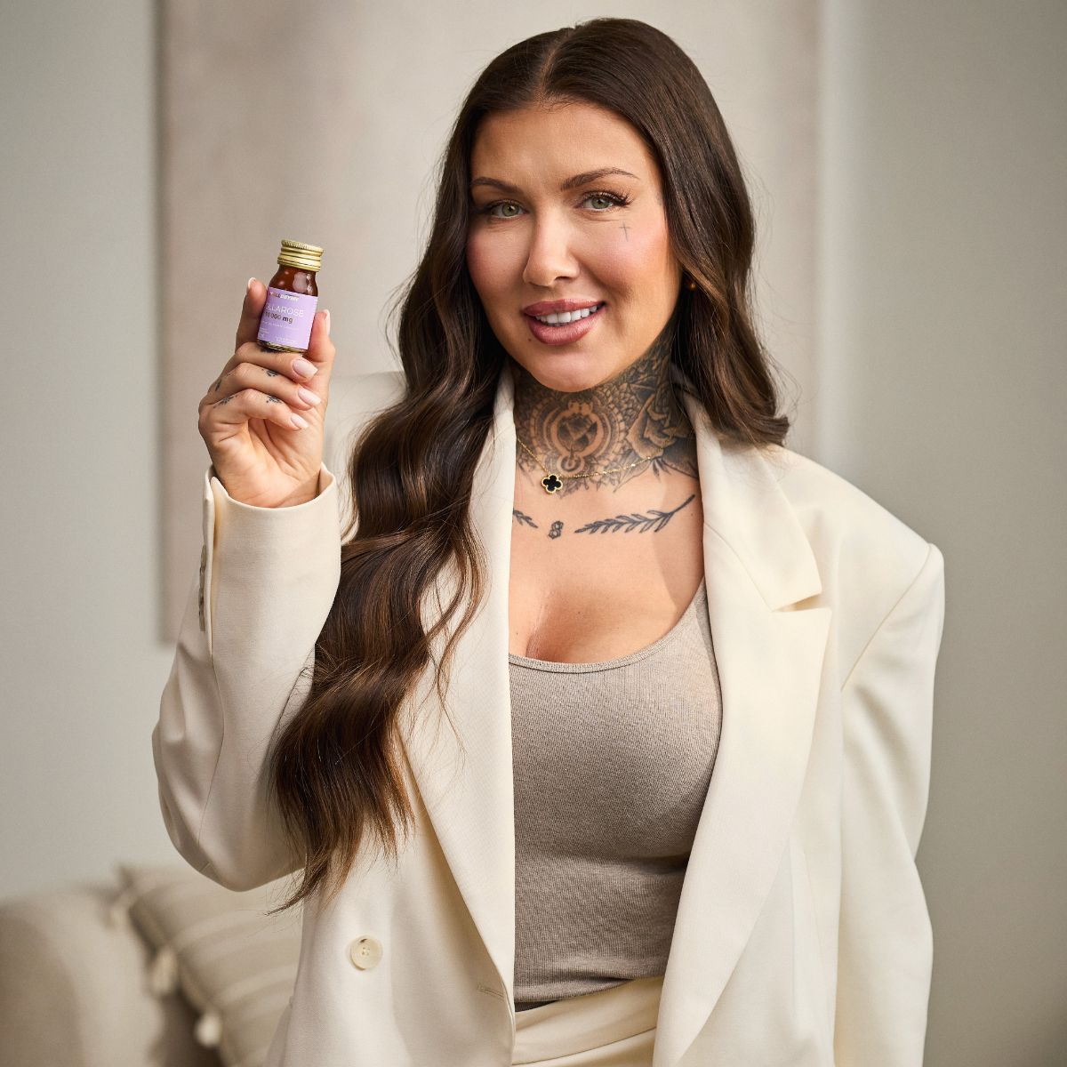 tattoo, neck, cream blazer, tank top, small bottle